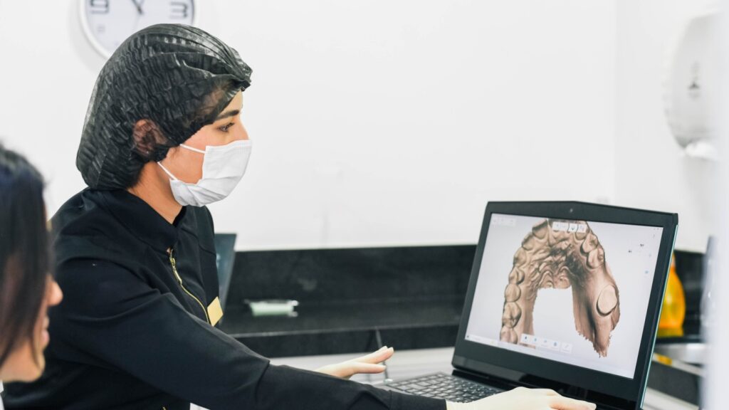 Digital dental lab tech reviewing 3D dental scans.
